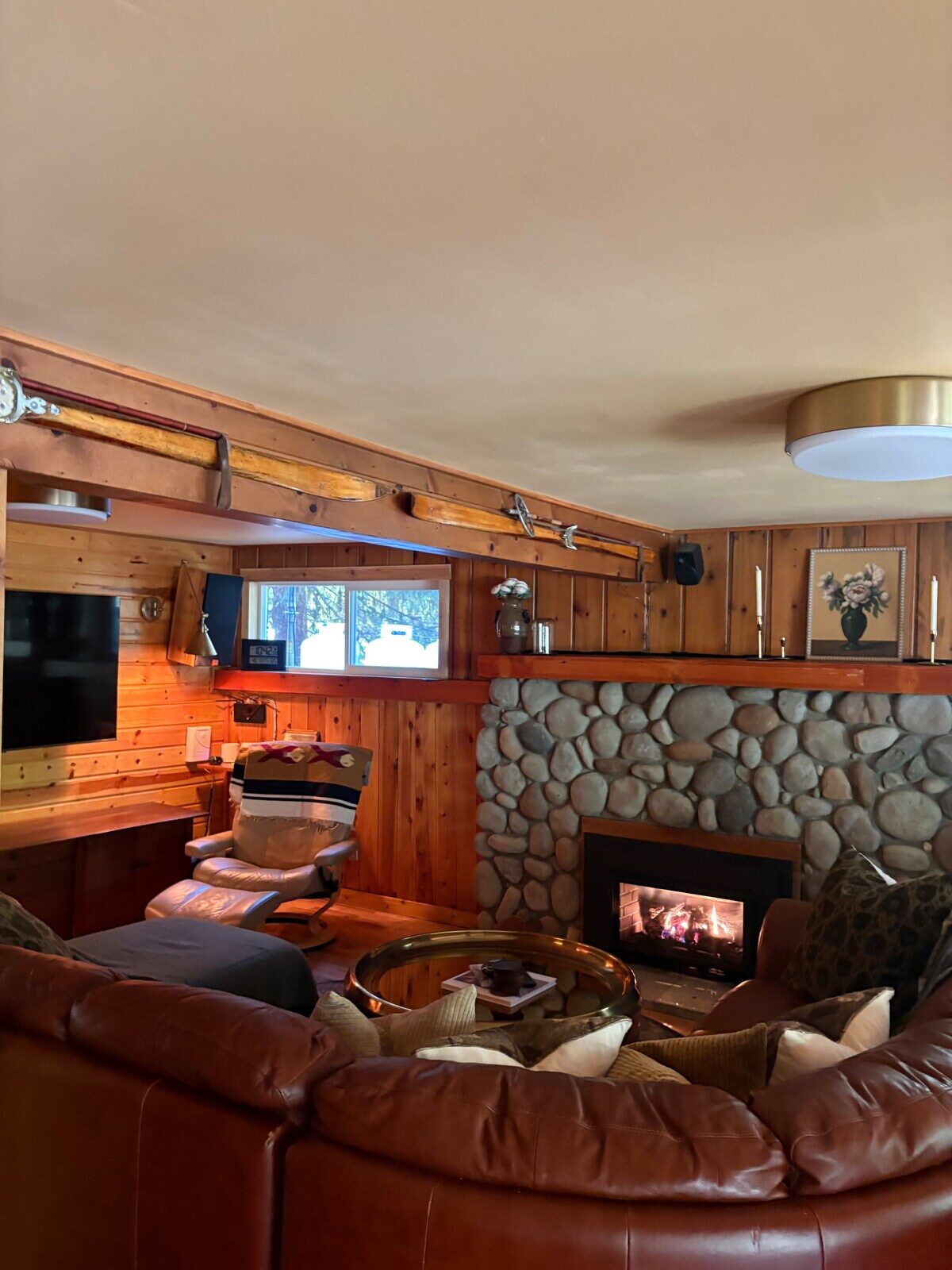 River-rock fireplace and leather sectional in the living room