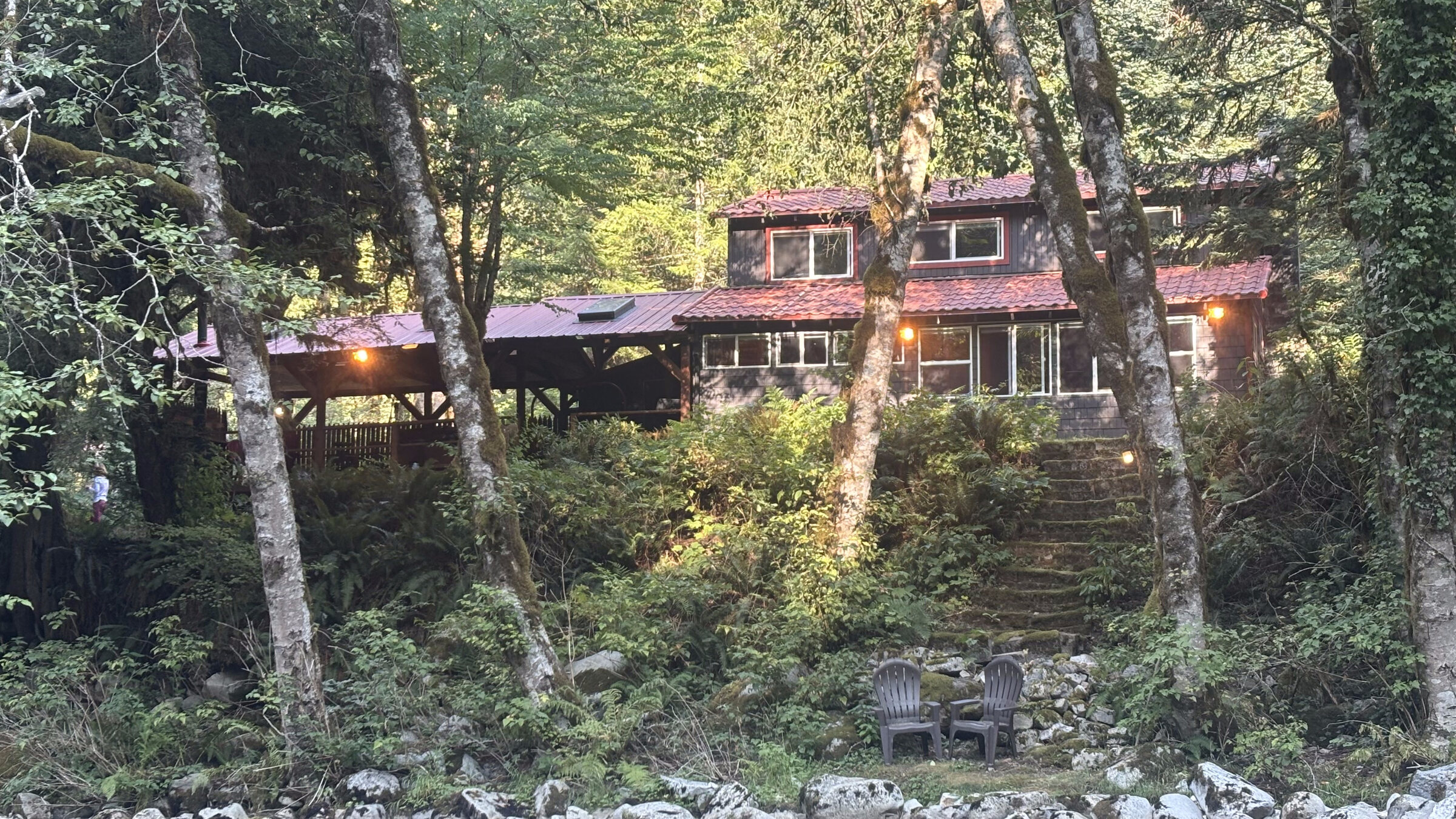 Foss River Cabin lit at dusk, seen from across the Foss River